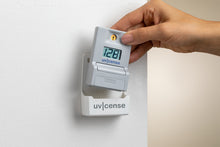 Load image into Gallery viewer, UVCense dosimeter removing from wall mount